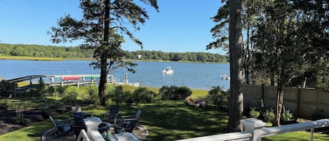 A lakeside deck with outdoor seating and a view of the lake.