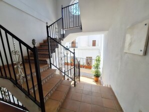 A staircase with ornate metal railings leading to an upper floor. - Catalina C (Turre)