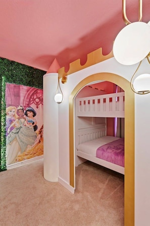 Ein Kinderzimmer mit Etagenbett, Wandbild und Deckenleuchte.