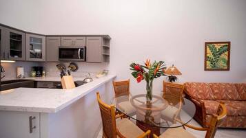A compact living space with a kitchen, dining area, and seating.