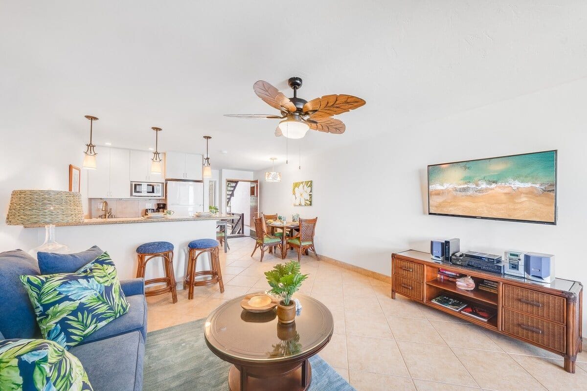 A modern living room with a sofa, coffee table, and dining area.