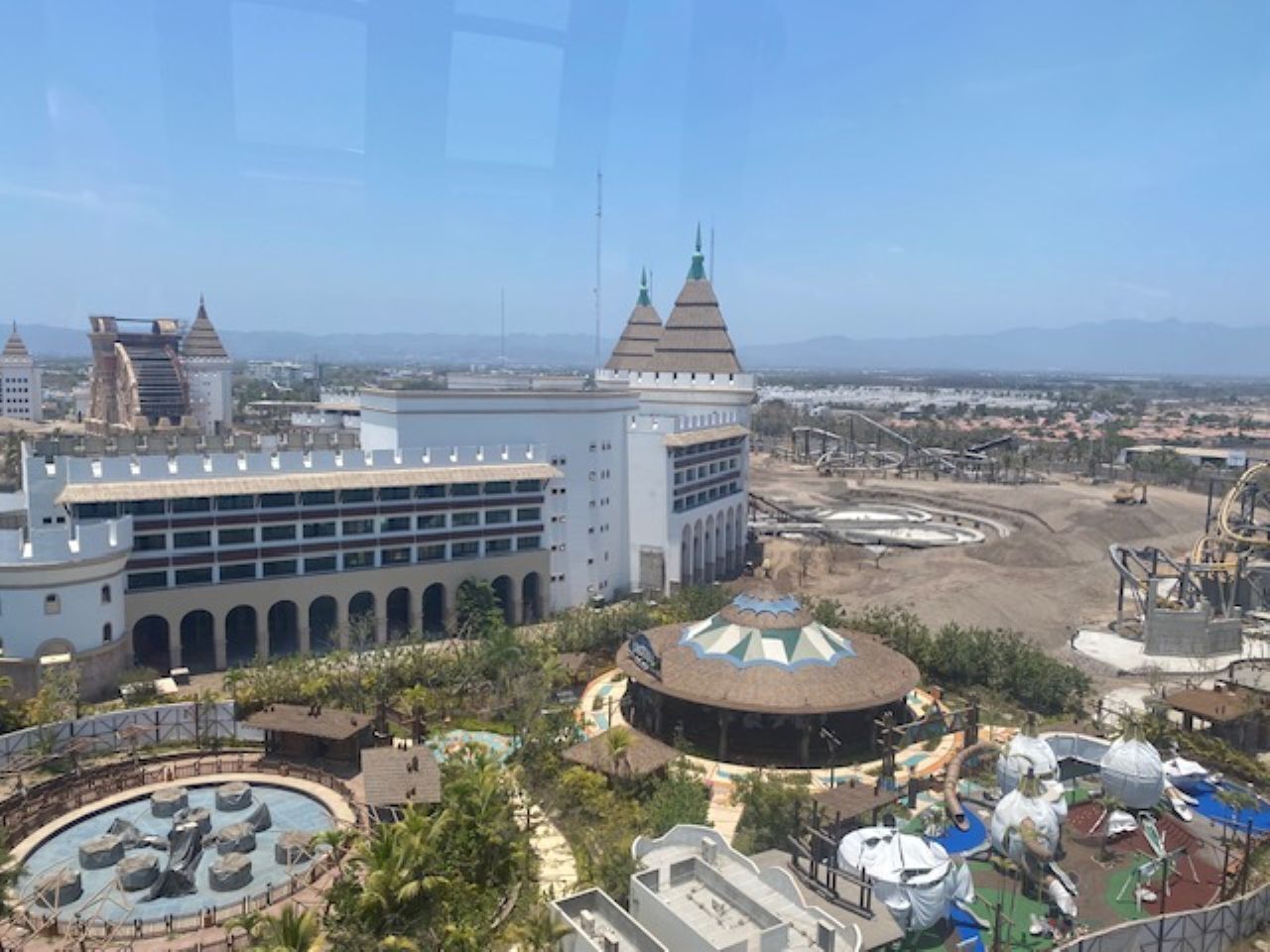 A resort with a large building, a circular pool area, and a dome structure.