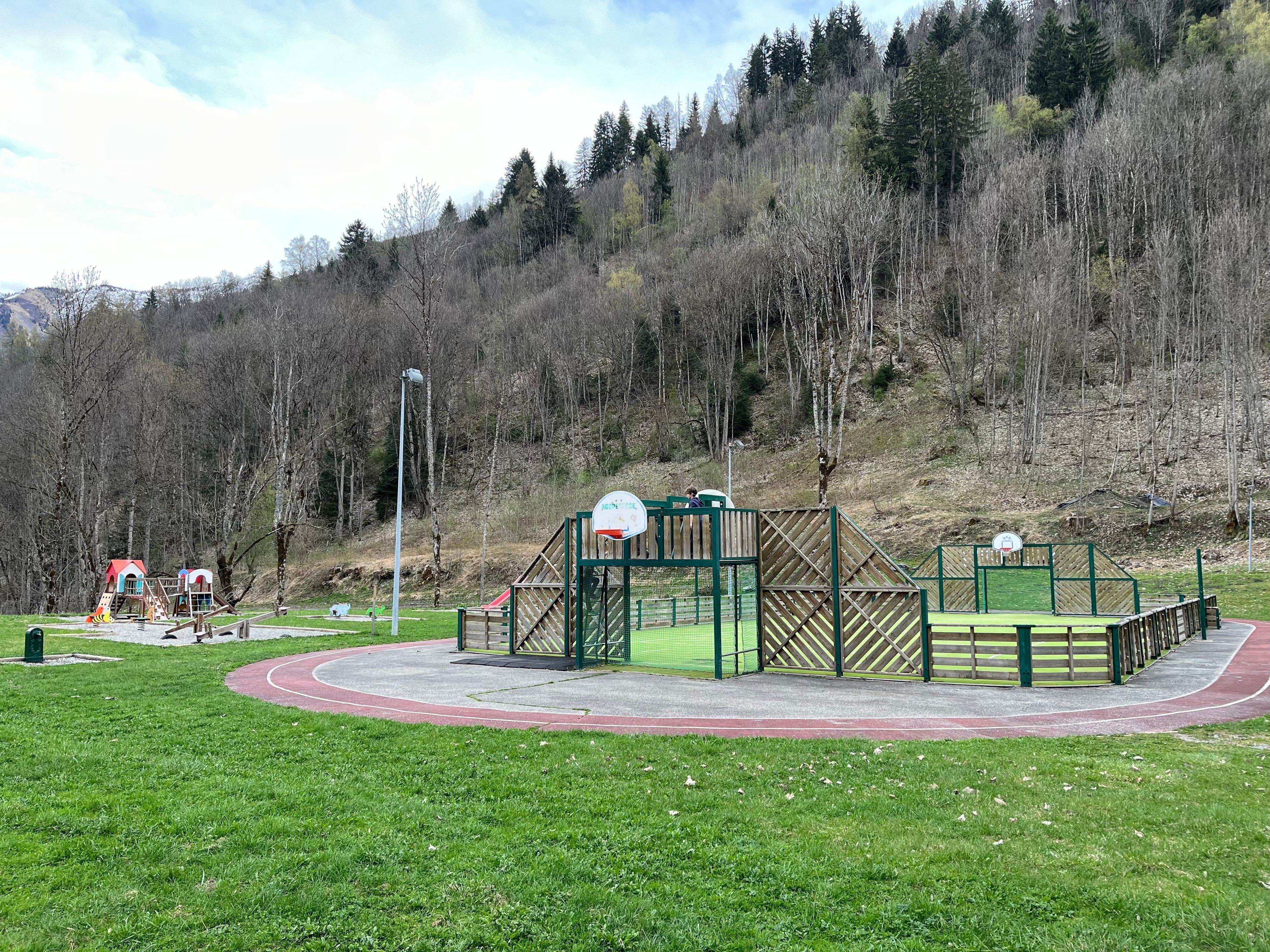 A playground with a running track and a basketball court.