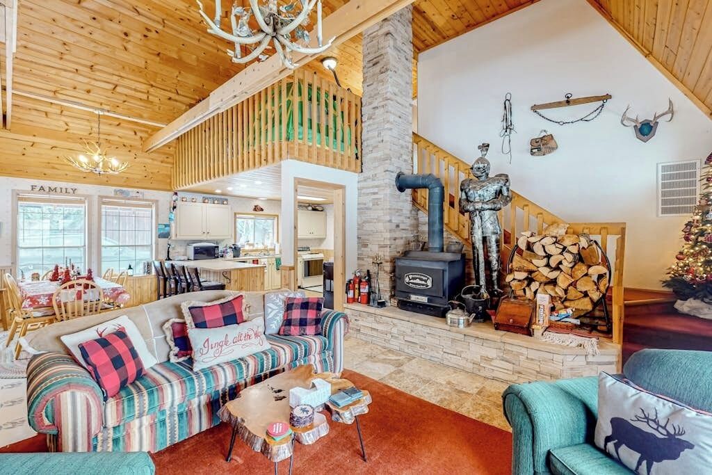 A cozy living room with a fireplace, a sofa, and a dining area.