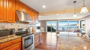 A modern kitchen with granite countertops, stainless steel appliances, and wooden cabinets.