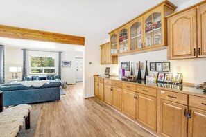 A modern kitchen with wooden cabinets and a built-in refrigerator. - ski-in and out 3BR with mountain views & fireplace (Snoqualmie Pass)
