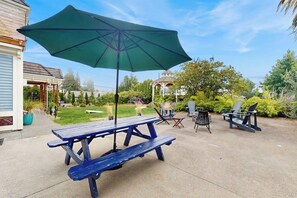 An outdoor patio with a picnic table and chairs, a gazebo in the background, and a clear sky. - 3 BR home with picnic area and dog-friendly (Shoreline)