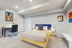 A bedroom with a bed, desk, chair, and artwork on the walls. - 3 BR home with picnic area and dog-friendly (Shoreline)