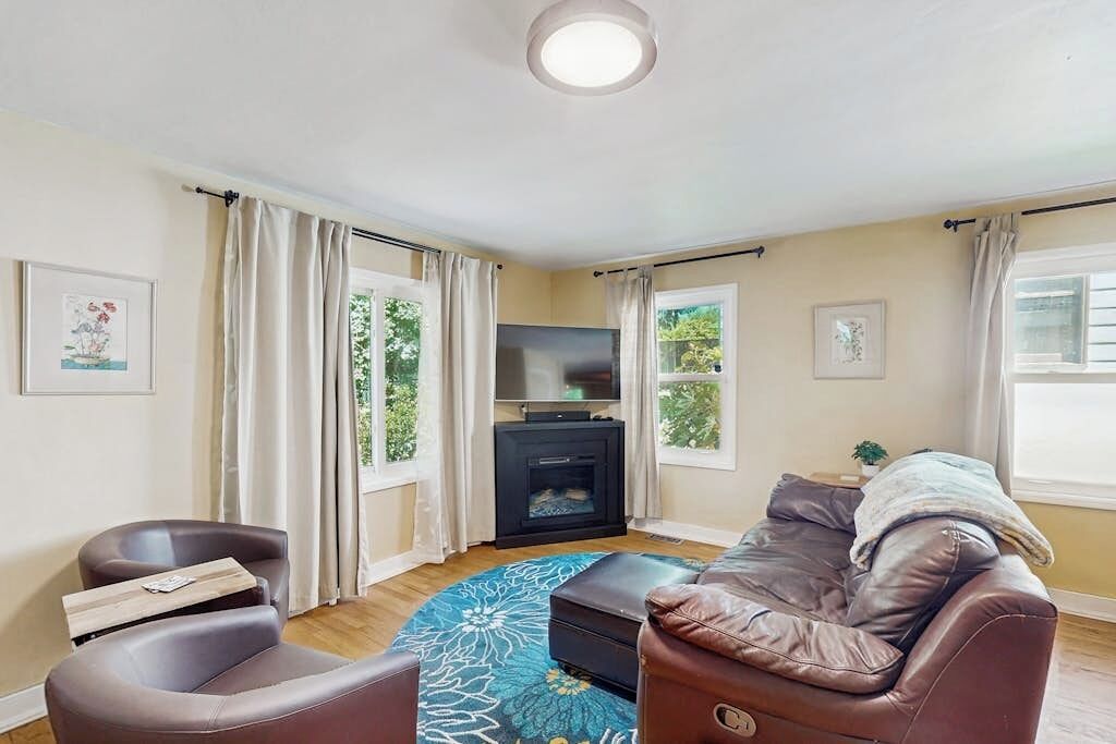A living room with a sofa, a television, and a fireplace.