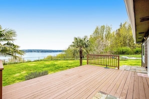 A wooden deck with a view of a lake and trees. - 3BR Sound Views - Deck - Washer Dryer - AC - Yard (Poulsbo)