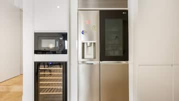 A stainless steel refrigerator with a water dispenser and a freezer compartment.