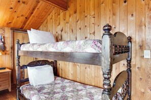 A bunk bed with a floral-patterned mattress and a wooden headboard. - Spacious 2BR Oceanview Dog Friendly - Hot Tub (Port Angeles)