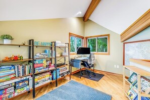 A room with a desk, computer, and bookshelves filled with various books. - Stunning 3BR Oceanfront Dog Friendly - Dock (Tahuya)