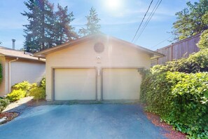 A single-story house with a garage, a visible address number, and a driveway. - 2BR Lakefront home with deck & garage parking (Lake Forest Park)