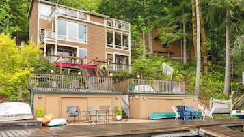A multi-story building with a deck and outdoor seating area.