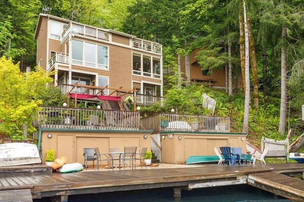 A multi-story building with a deck and outdoor seating area.