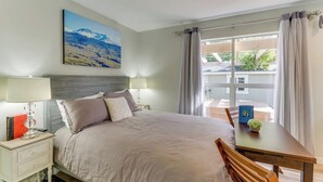 A bedroom with a bed, bedside tables, a window with curtains, and a painting on the wall. - Downtown | Lakeview | Deck | Hot Tub (Mercer Island)