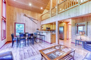 A spacious wooden interior with a dining area, kitchen, and a balcony. - 4BR Mountainview Dog Friendly - Hot Tub - Deck (Skykomish)