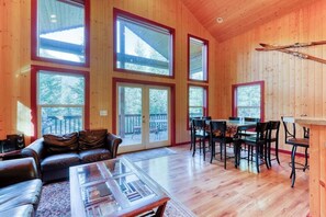 A wooden interior with a sofa, coffee table, and dining area. - 4BR Mountainview Dog Friendly - Hot Tub - Deck (Skykomish)