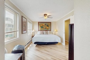 A hotel room with a bed, a ceiling fan, a heater, and a window with blinds. - Downtown 1BR Washington State Conv. Center 14th-fl (Seattle)