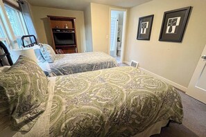 A bedroom with two beds, a dresser, a chair, and a window. - Lovely 4BR Lakeview - Game Room - Foosball (Seattle)