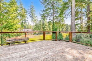 A wooden deck with a metal railing, surrounded by trees. - Custom 3BR Golf Course View - Chef's Kitchen (Union)