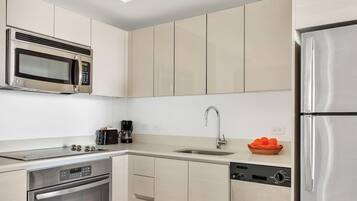A modern kitchen with stainless steel appliances, a dishwasher, and a coffee maker.