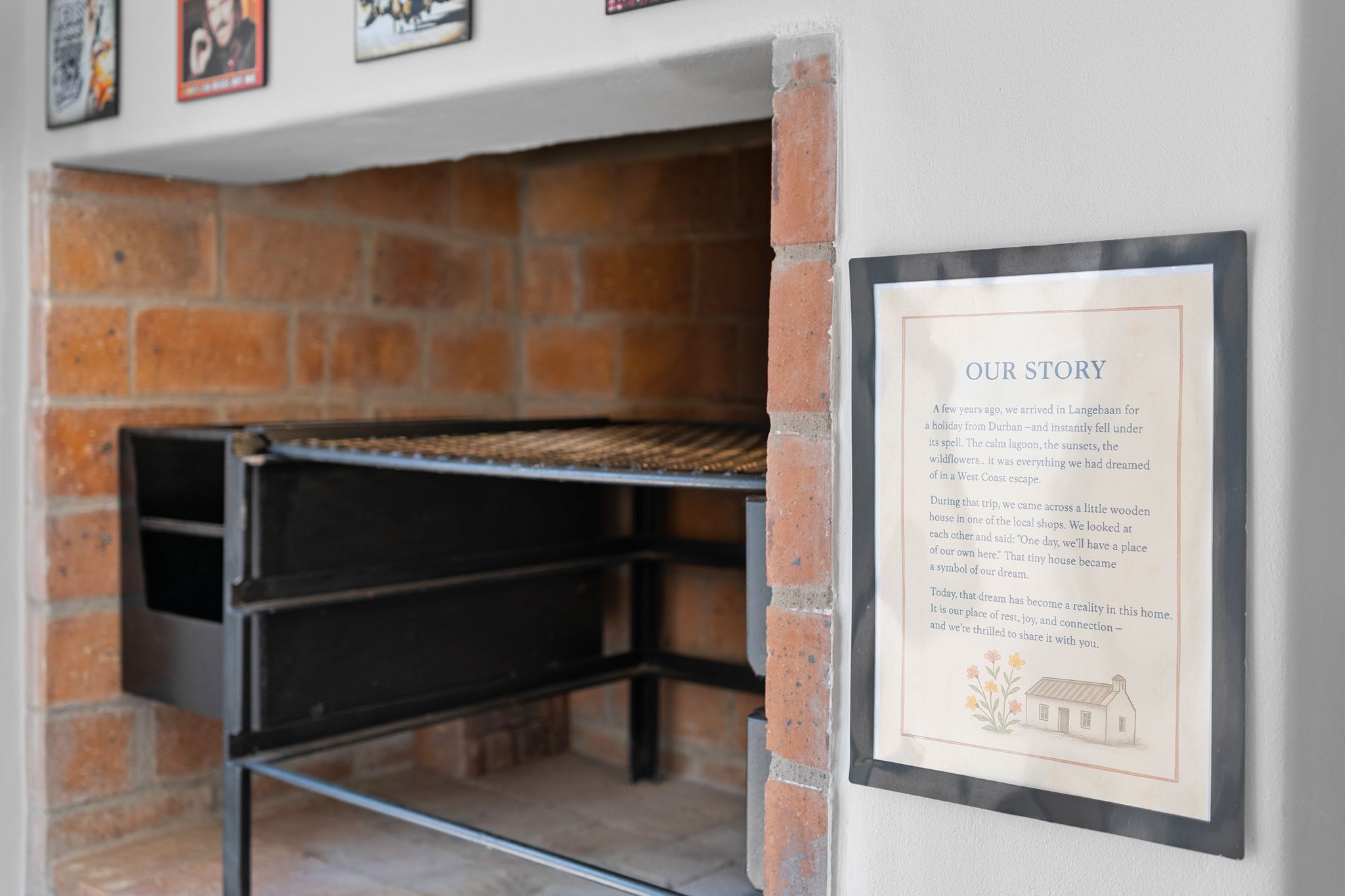 A framed text panel titled 'OUR STORY' against a brick wall, with a metal rack above it.