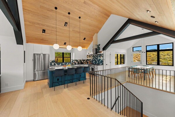 A modern kitchen with a central island, stainless steel appliances, and a view of the outdoors. - Larkspur Haven, luxury, close to trails & town of CB, has tennis, pickleball! (Crested Butte)