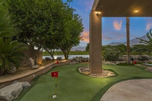 A golf course with a water body in the background, a flag marked '1', and a well-maintained lawn. - 9th Hole Turn.  On the world famous Stadium Course!  Lake, Golf and MNT Views! (La Quinta)