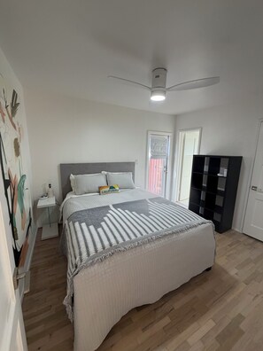 A bedroom with a bed, a nightstand, a ceiling fan, and a wardrobe. - Lovely 3-bedroom house with AC in peaceful Sierra Madre at base of Mount Wilson. (Sierra Madre)