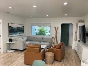 A modern living room with a sofa, armchairs, a coffee table, and a television. - Lovely 3-bedroom house with AC in peaceful Sierra Madre at base of Mount Wilson. (Sierra Madre)