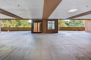 An empty interior space with a high ceiling, large windows, and a central door. - Luxury Condo, Free Hot Springs Spa Day & Dollywood (Gatlinburg)