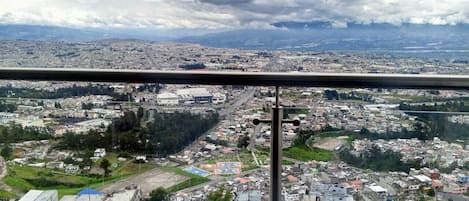 A cityscape with buildings, roads, and a distant mountain range.