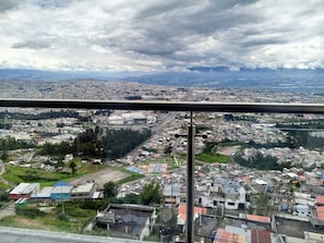 A cityscape with buildings, roads, and a distant mountain range.