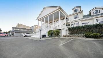 A multi-story building with a central staircase and a covered porch.