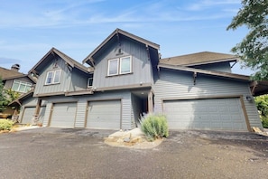 A two-story house with a garage and a driveway. - 2 BR Townhome at the Villages at Roslyn Ridge (Ronald)