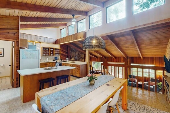 A spacious kitchen with a central island, wooden beams, and large windows. - 3BR Lakefront Gas Grill - Deck - Firepit (Hoodsport)