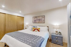 A bedroom with a bed, bedside tables, a wardrobe, and a painting on the wall. - 3BR Lakefront Gas Grill - Deck - Firepit (Hoodsport)