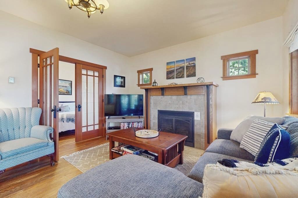 A living room with a fireplace, a television, and a sofa.