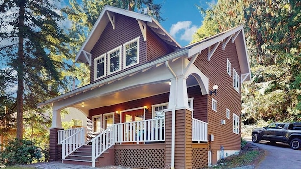 A two-story house with a porch, a staircase, and a vehicle parked outside. - 3BR Oceanfront Dog Friendly | Fireplace (Port Townsend)