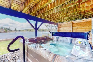 A hot tub with a wooden deck and a view of a lake. - 4BR dog-friendly with water views & deck (Shelton)