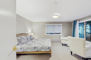 A hotel room with a bed, a chair, a window, and a ceiling light. - 5 BD ocean view home with private hot tub (Moclips)