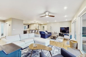 A modern living room with a sectional sofa, a coffee table, and a television. - 5 BD ocean view home with private hot tub (Moclips)
