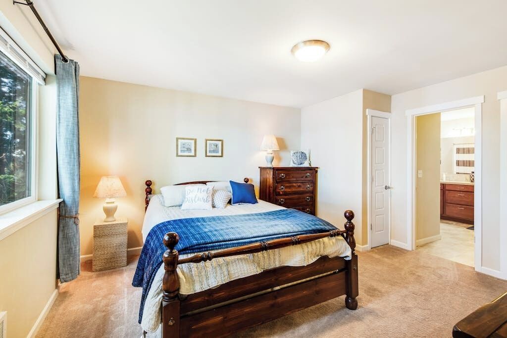 Une chambre à coucher avec un lit en bois, une table de chevet avec une lampe et une commode.