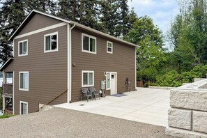 A two-story building with a flat roof, multiple windows, and a paved driveway.