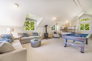 A spacious living area with a pool table, sofas, a fireplace, and a staircase. - Stunning 5BR Oceanview Birch Bay Dog Friendly (Blaine)