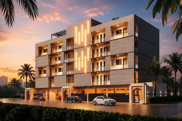 A multi-story hotel with a modern design, featuring balconies, a parking area, and a gated entrance. - Estaaron Crave - Villas and Apartment Hotel (Tema)