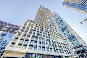 A high-rise building with multiple floors, large windows, and a modern architectural design.