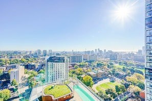A high-rise building with a rooftop garden and a pedestrian walkway. - StayToronto - The Jarvis Condos (Toronto)